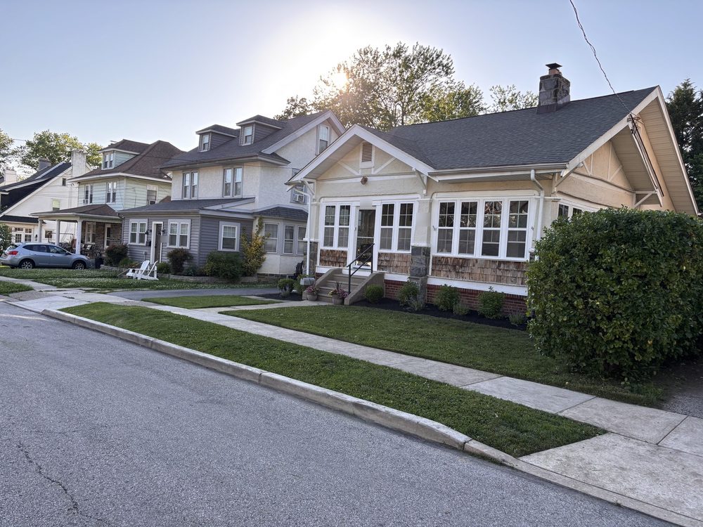 Freshly cut front lawn and curb strip in front of a bungalow